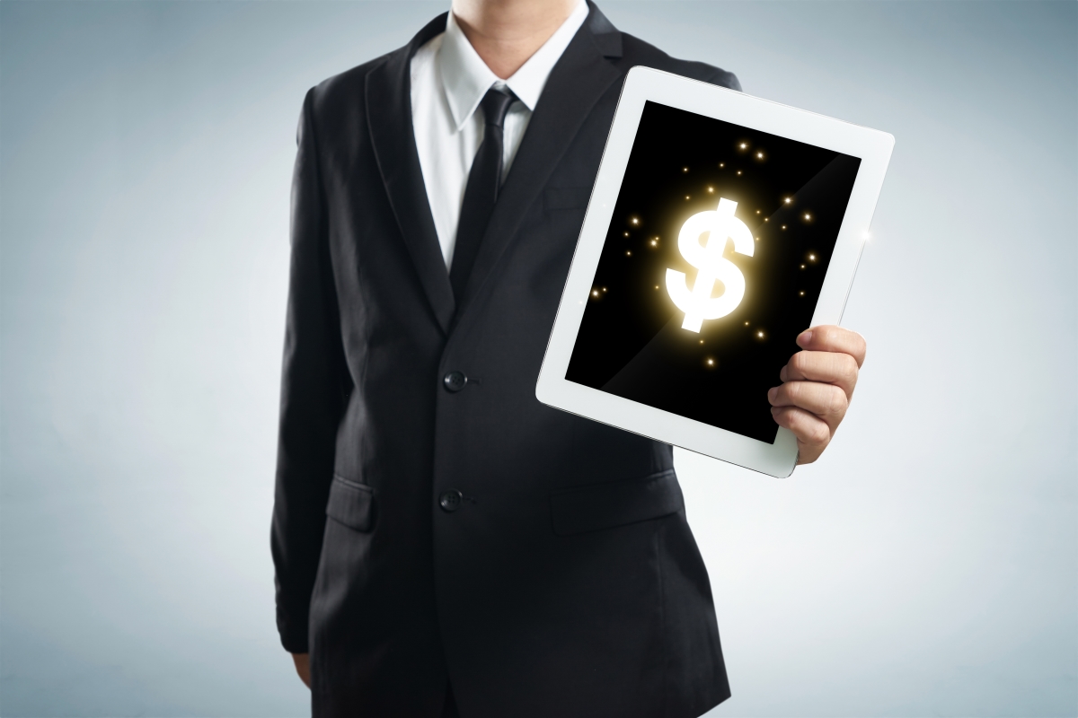 Optimized-graphicstock-successful-young-businessman-shows-the-screen-of-the-tablet-with-dollar-symbo_BdPdiwxox